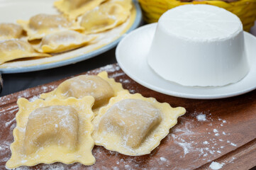 Italian food, fresh home made stuffed pasta ravioli dumplings with ricotta soft cheese and champignons porcini mushrooms, Parma, Emilia Romagna, Italy