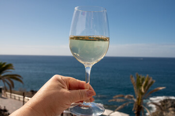 Celebration, birthday party, drinking of cold dry white wine in vacation resort Costa Adeje, Tenerife, Canary islands winter sun vacation, Spain