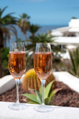 Celebration, birthday party, drinking of rose cava or champagne sparkling wine in vacation resort Costa Adeje, Tenerife, Canary islands winter sun vacation, Spain