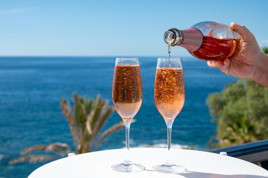 Celebration, birthday party, drinking of rose cava or champagne sparkling wine in vacation resort Costa Adeje, Tenerife, Canary islands winter sun vacation, Spain