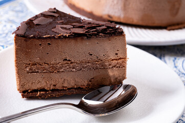 Piece of dark chocolate ice cream frozen cake on board