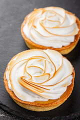 Lemon tart sweet dessert meringue, lemon curd tasty fresh gourmet food background table rustic food top view copy space