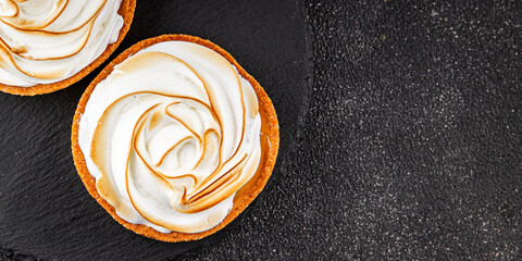 Lemon tart sweet dessert meringue, lemon curd tasty fresh gourmet food background table rustic food top view copy space