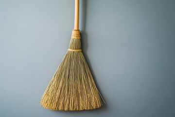 A broom hangs on a wall in a home interior setting
