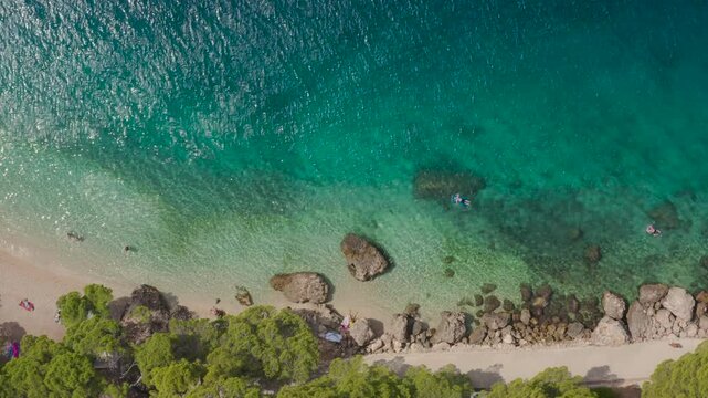 Picturesque aerial view beaches with vacationers, turquoise sea at popular resort Brela, Croatia.