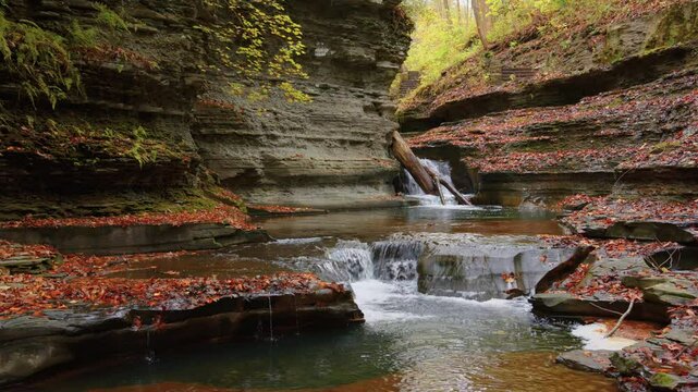 A clear view of the waterfall flowing through colorful autumn leaves at Buttermilk Falls in Ithaca, captured in ultra-high-definition 4K resolution.