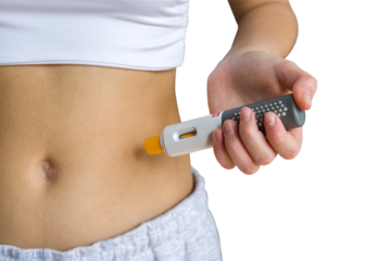 Young woman giving an self injection in the stomach