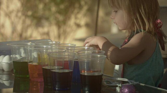Little Girl Dyeing Easter Eggs