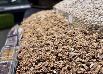 Large peeled walnuts are sold in large quantities in a large tray on the market. Healthy eating....