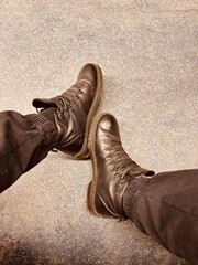 Casual Footwear Designed for Urban Surfaces Stylish and Trendy Sneakers to Wear. A pair of stylish sneakers is resting on a uniquely textured urban surface, showcasing modern casual street fashion