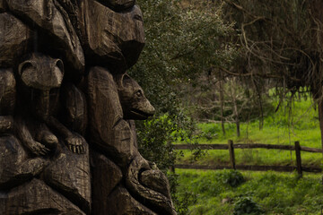 A beautifully hand-carved wooden sculpture featuring various animal figures emerges from a tree...