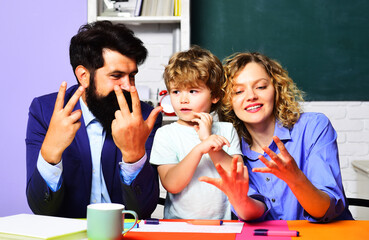 Child boy in classroom study mathematics with teachers and counting on fingers. Mathematics for...
