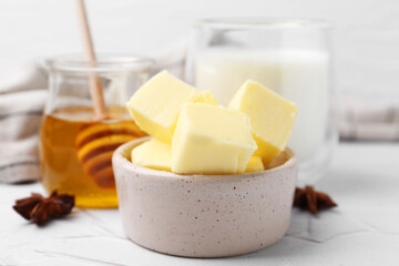 Sweet honey, butter and milk on white table