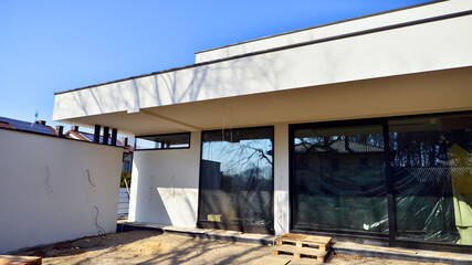 Obraz premium Single family house construction site. Modern designed single-family house under construction.