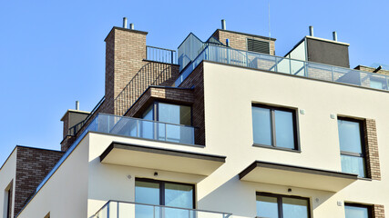 Apartment building with  symmetrical modern architecture in the city. Modern apartment building on a sunny day. Facade of a modern apartment building. Bottom view. 