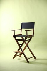 Fototapeta premium One empty director's chair on pale olive background