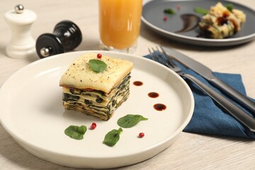 Piece of tasty spinach lasagna on wooden table, closeup