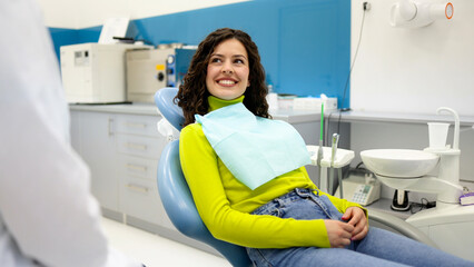 Young woman sitting on a dental chair