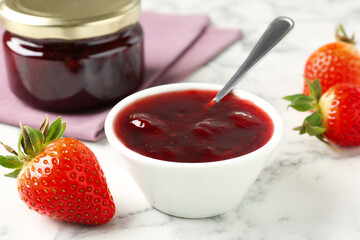 Delicious strawberry sauce and fresh berries on white marble table, closeup