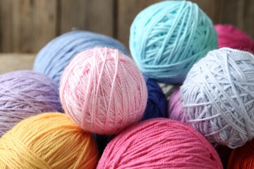 Balls of colorful yarn on table, closeup