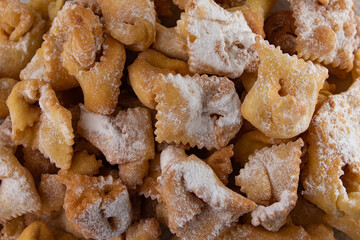 Homemade crispy Chiacchiere cookies, dusted with powdered sugar. Fried in oil, these traditional Italian carnival treats are light, crunchy, and perfect for festive celebrations.