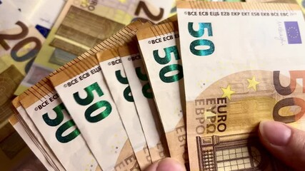 Counting euro banknotes. Female hands count 50 euros cash. Investments, family budget and savings concept	