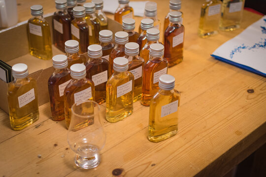 Close-Up View of Small Scotch Whisky Sample Bottles on a Wooden Table