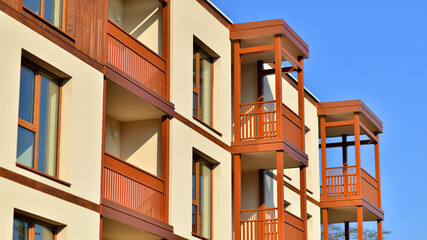 New apartment building. Residential area with modern apartment building. in sunny day. Fragments of the wooden facade.