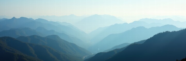 Obraz premium Serene mountain landscape featuring soft blue hues and fog, perfect for travel, nature, or wellness themes.