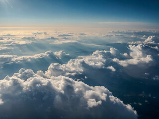 Fluffy white clouds illuminated by sunlight with a breathtaking aerial view
