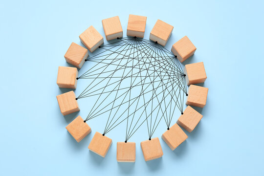 Frame made of wooden cubes on blue background