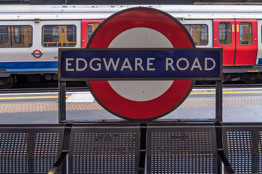 London, UK Edgware Road station sign with train platform view.
