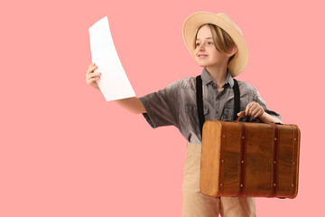 Little actor with suitcase and film script on pink background