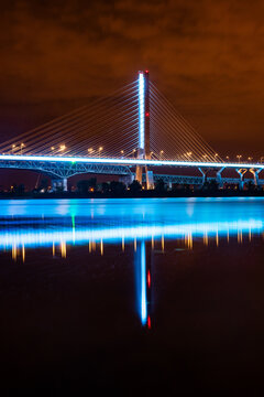 Champlain Bridge Illuminated at Night with Reflections in the River