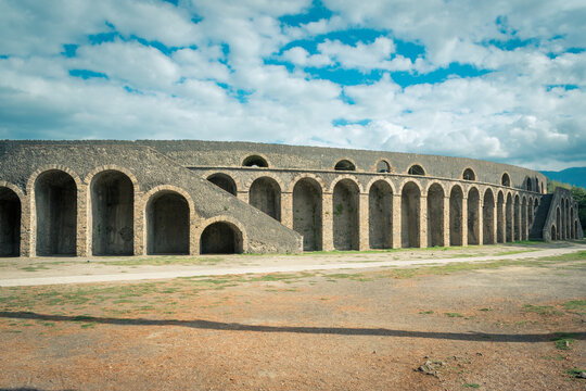 Ancient Roman Amphitheater in Pompeii Under a Scenic Blue Sky