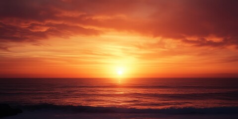 A serene sunset casts vibrant colors over the ocean as a person surfs on a board.