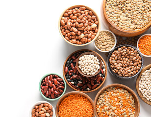 Composition with bowls of different raw legumes on white background