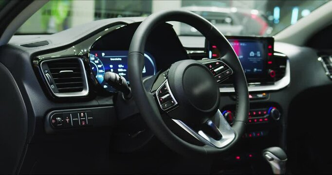 Electric car interior details adjustments. Inside car interior with front seats, driver and passenger, textile, multimedia, windows, console, gear shift, electric buttons, digital speedometer.
