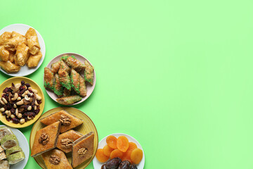 Tasty baklava and traditional sweets on green background. Nowruz Bayram celebration