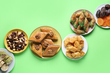 Tasty baklava and traditional sweets on green background. Nowruz Bayram celebration