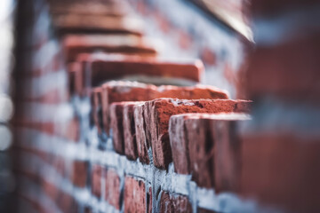 Close-Up of Textured Brick Wall with Warm Red Tones and Soft Focus