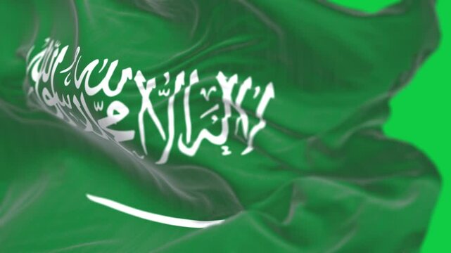Close- up of the Saudi Arabian national flag waving isolated on green background