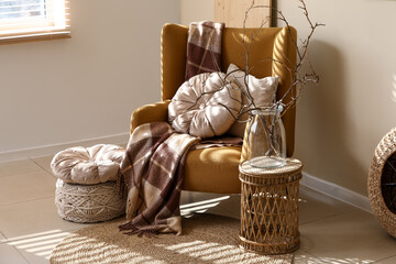 Interior of stylish living room with armchair and table