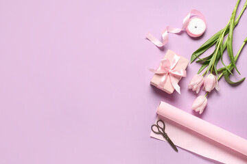 Gift box with tulips, wrapping paper and scissors on lilac background. International Women's Day