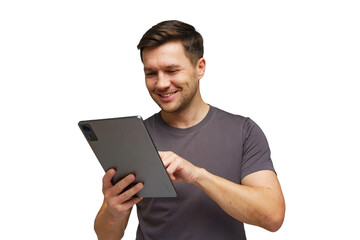 Young man smiling while using tablet in a bright setting, engaged in online activity