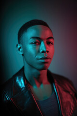 Fototapeta premium Stylish Young Man with Confident Expression in Modern Two-Tone Lighting