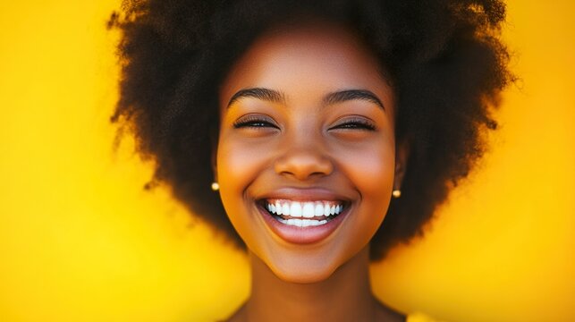 A joyful African-American girl’s bright smile radiates warmth and happiness.