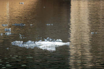 Winter ice drifting down a river during a thaw
