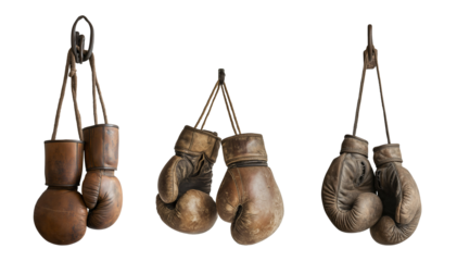 Vintage boxing gloves hanging in a rustic setting, showcasing the history and craftsmanship of the sport