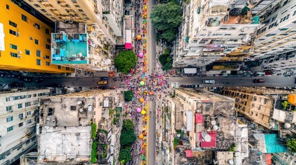 Fototapeta premium Aerial View of a Colorful Street Festival in a Dense City.